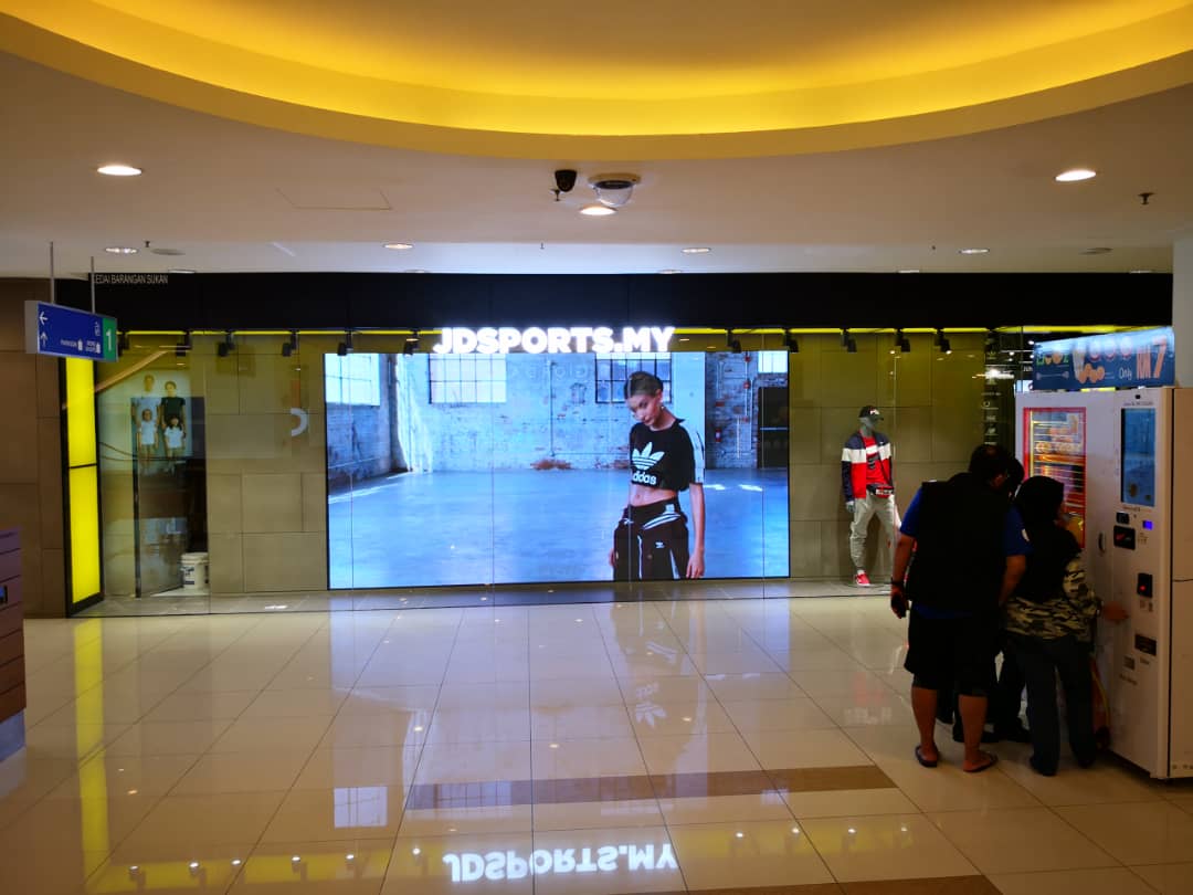 Indoor LED screen displaying JD Sports promotional visuals in Penang store