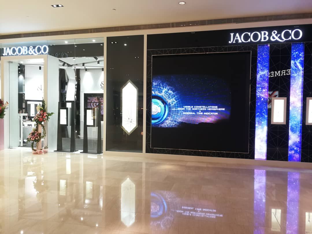 A wide shot of a Jacob & Co. LED screen installation integrated into a contemporary storefront