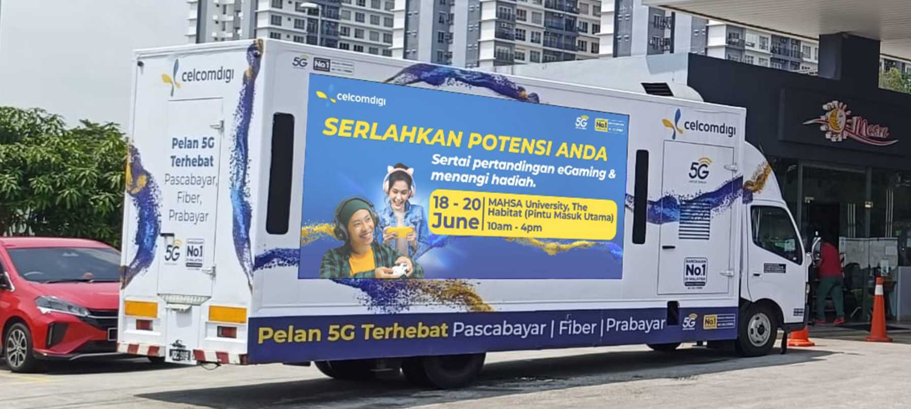 Celcom Digi digital advertising truck parked outdoors, featuring dynamic visuals