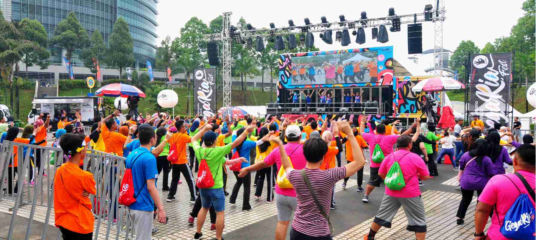 GoGegaria warm up session in front of a truck-mounted LED screen
