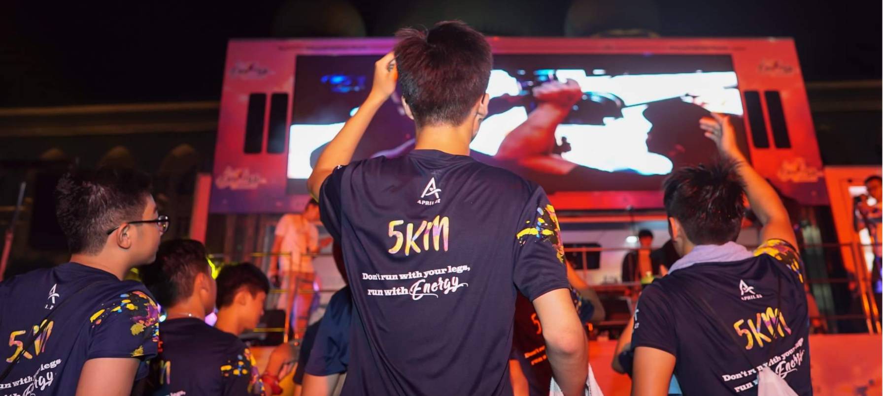 People enjoying the truck-mounted LED screen in Energy Run event