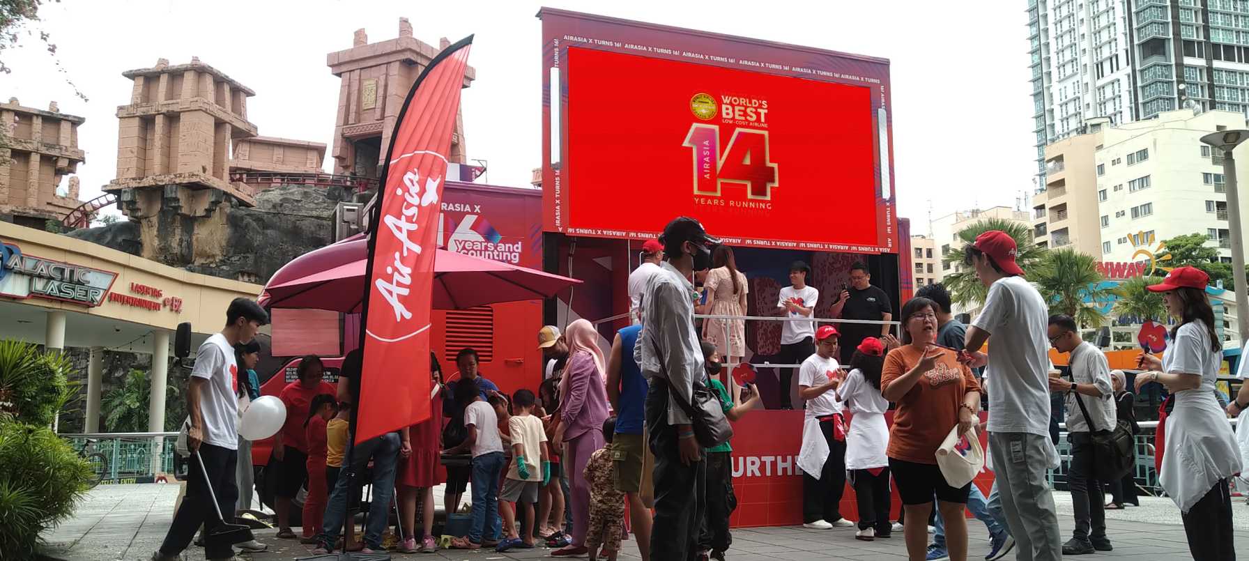 People lined up after seeing advertisement at AirAsia truck-mounted LED screen