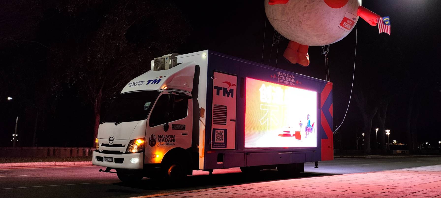 Truck-mounted LED screen illuminated at night, enhancing the atmosphere
