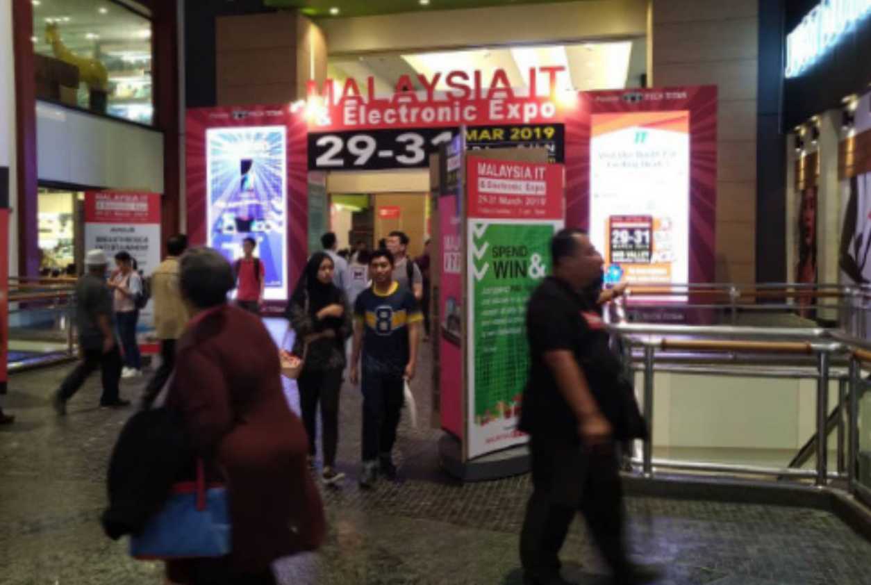 Attendees engaging with an eye-catching LED screen