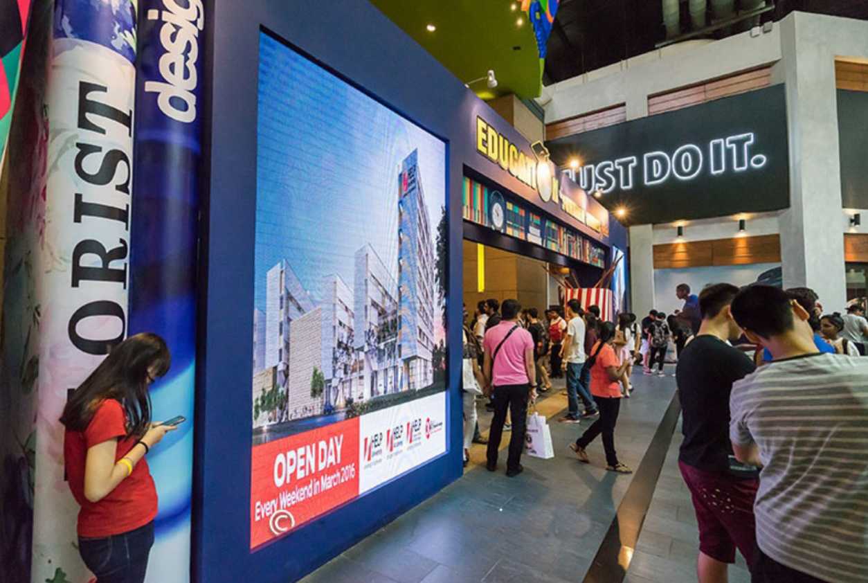 LED screen displaying academic programs and scholarships at the Education & Further Studies Fair