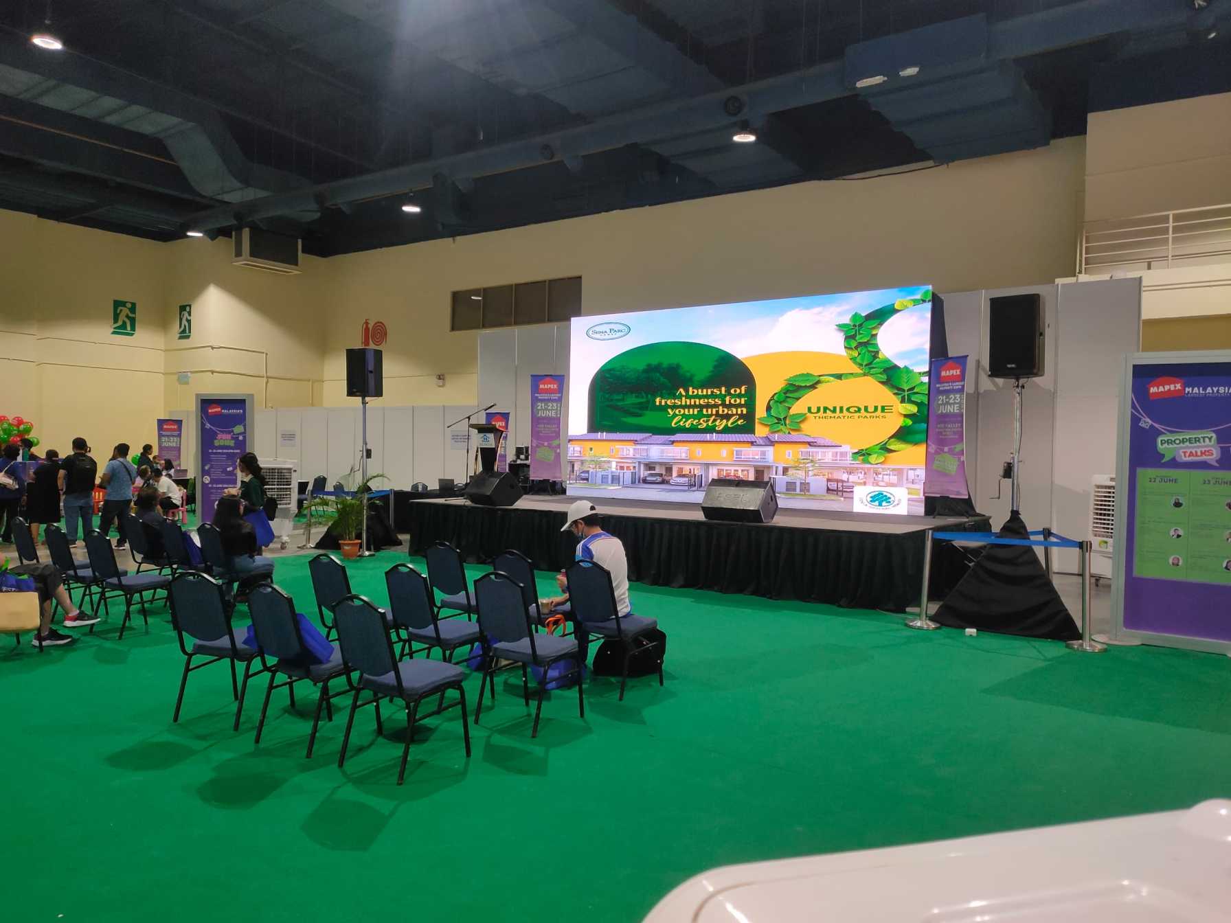 Prominent LED screen showcasing property listings