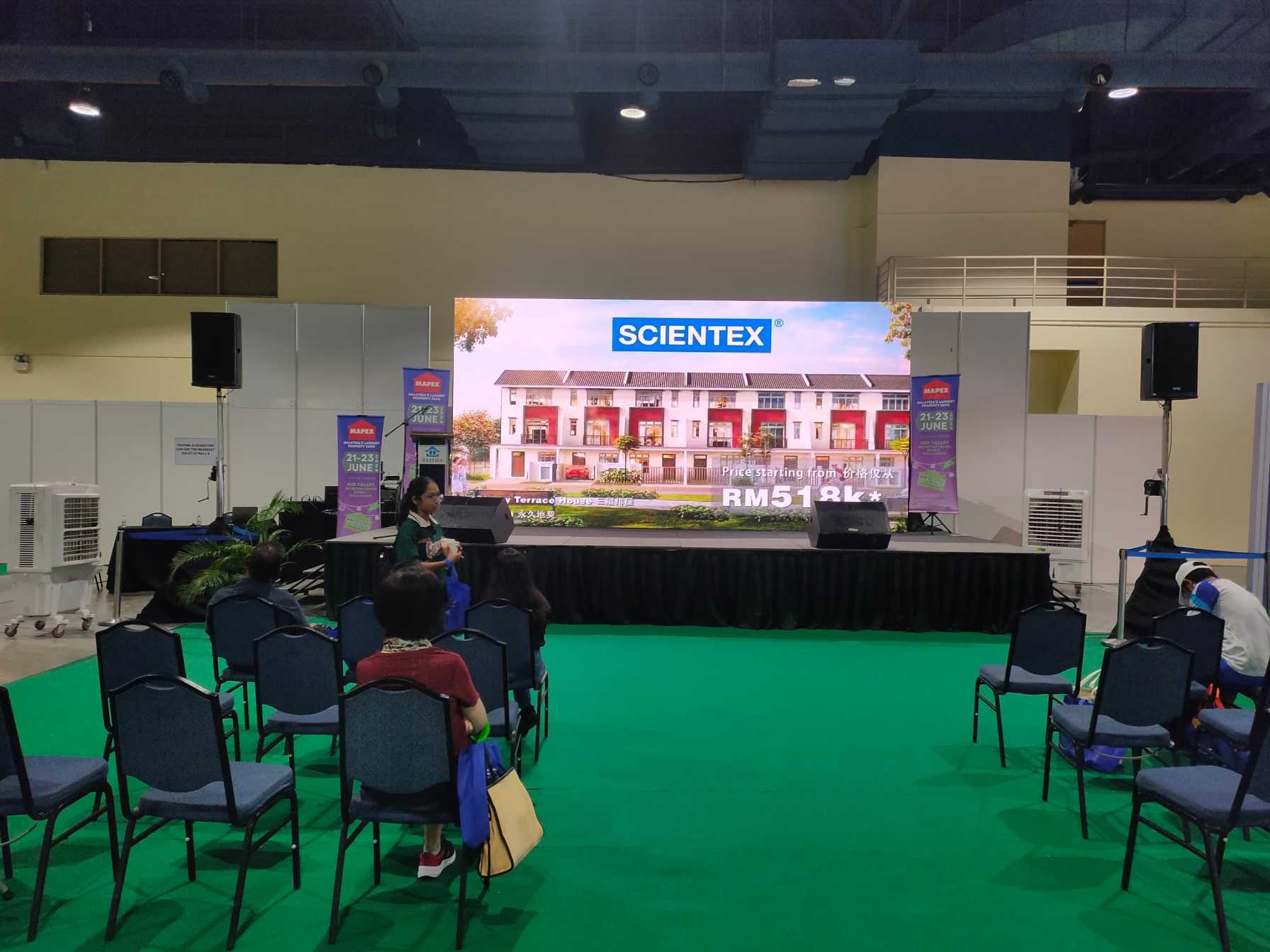 Visitors interacting with an LED screen rental at MAPEX